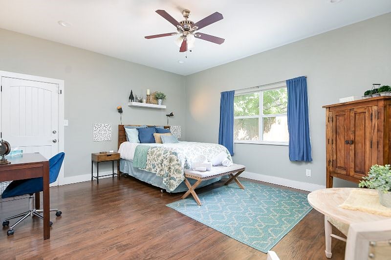 Bedroom 1 with queen size bed and desk.