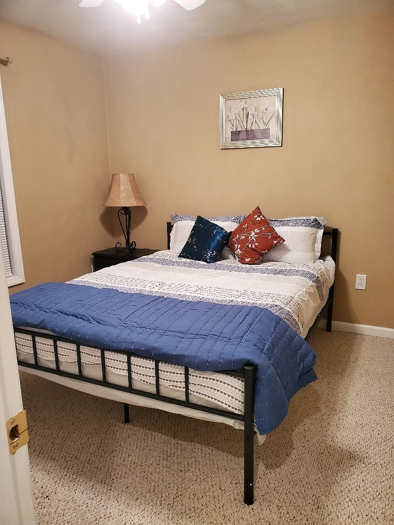 Bedroom 3 with another queen bed and 2 pillows.