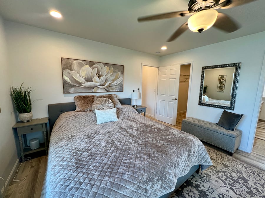 Upstairs Master Bedroom with King size Bed, Sitting area, Smart TV, walk-in closet and en-suite bath.