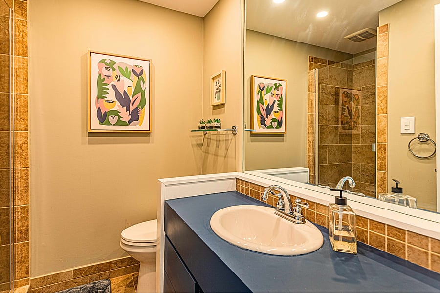 The spacious downstairs bathroom with a walk-in shower, large mirror and ample counter space.