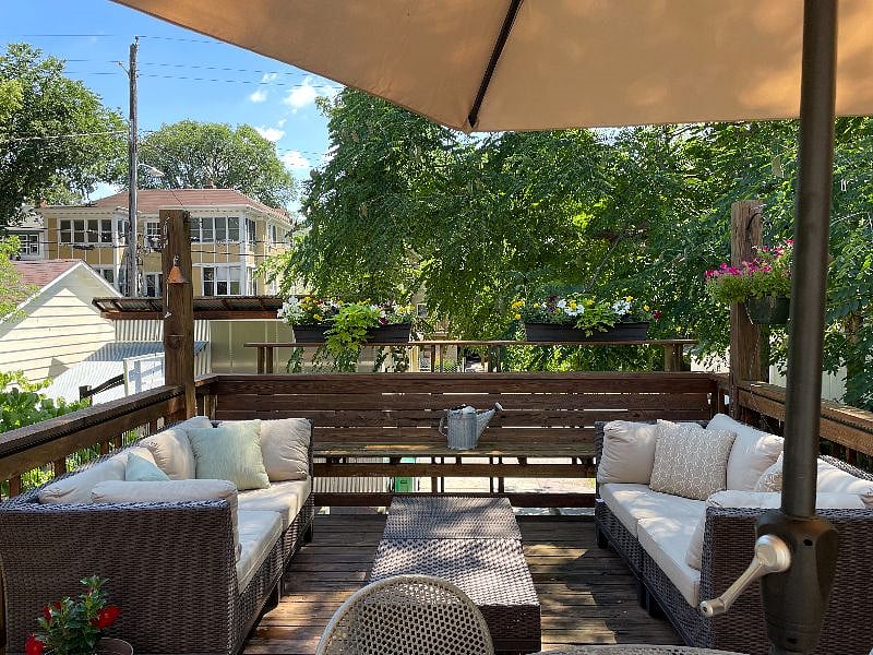 Back deck with seating and dining table.