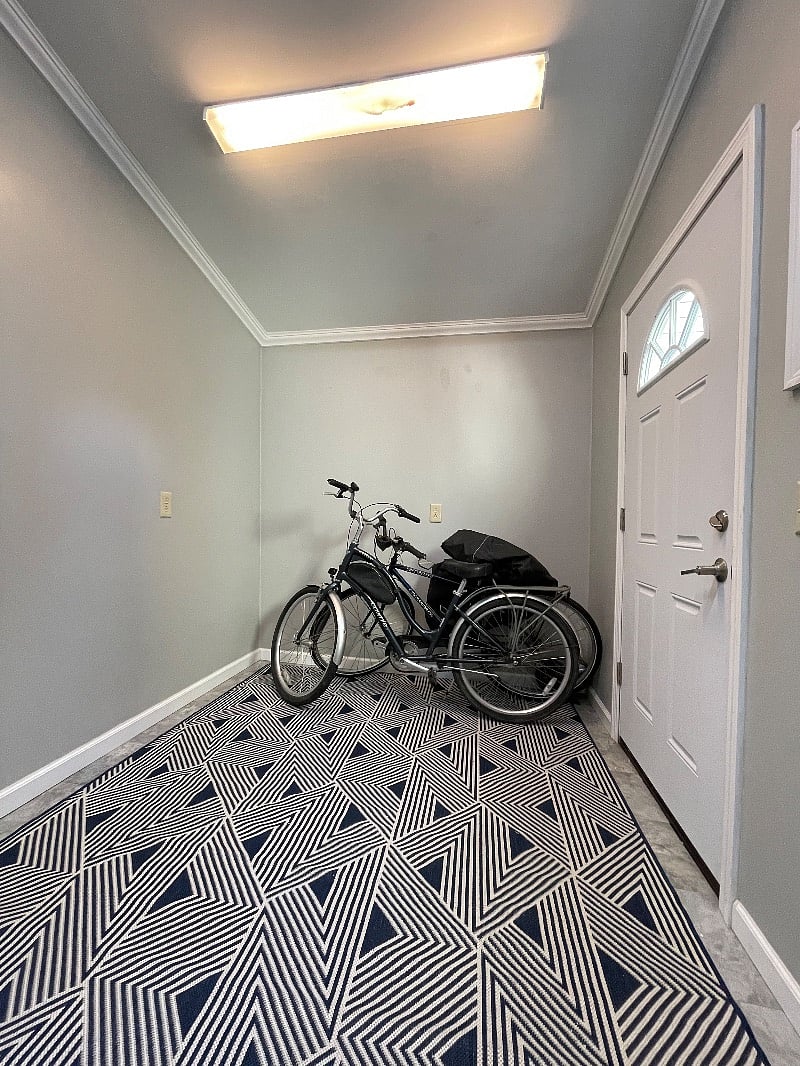 multi-purpose room showing bicycles for your use and door leading to enclosed private patio