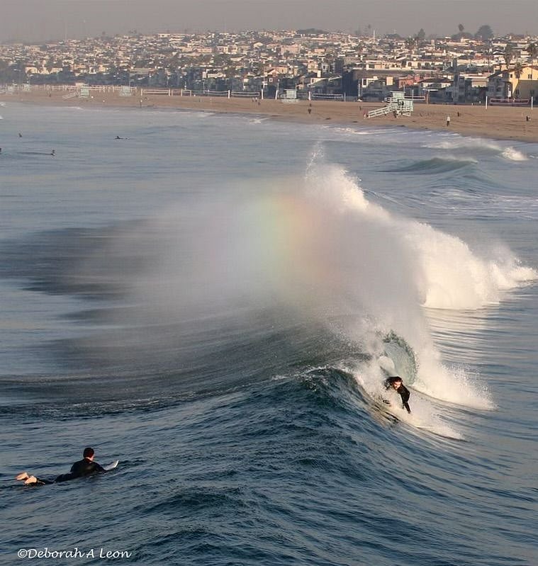 Surfing waves and rainbow Hermosa Beach