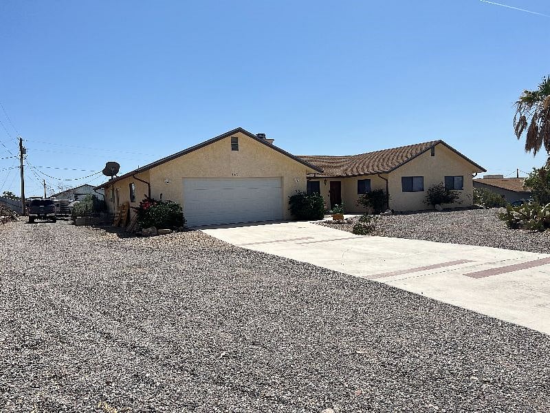 Front of house with large driveway parking
