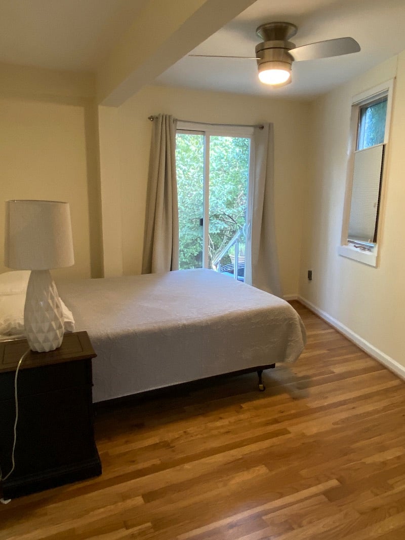 Bedroom with queen sized tempurpedic bed brings the outdoors in with a sliding glass door to a private backyard patio