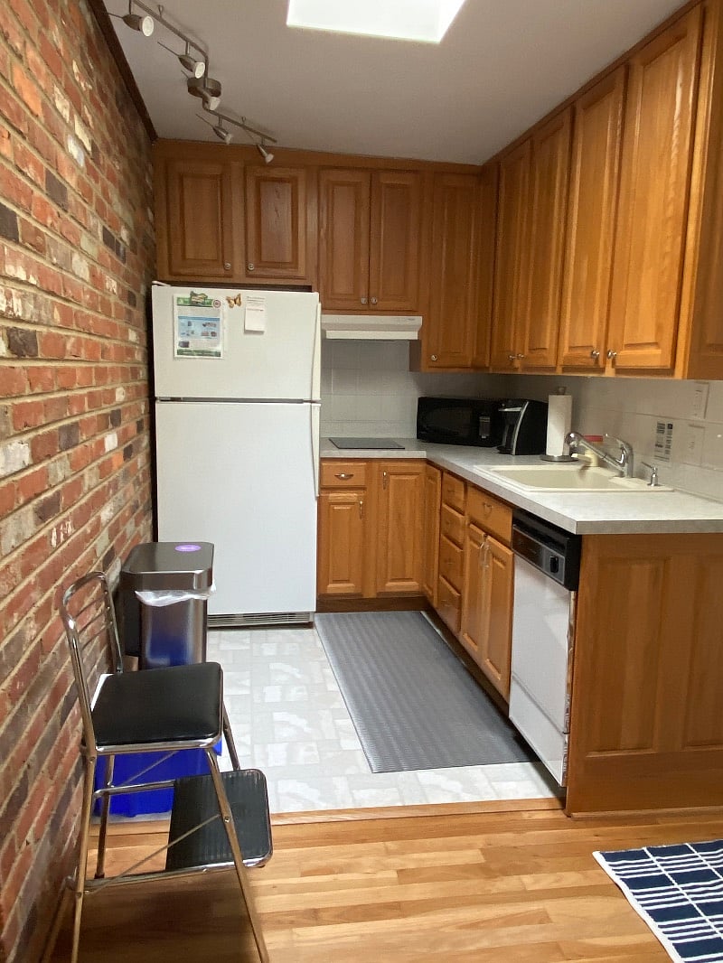 This kitchen has it all!  Natural light from a skylight, an induction cooktop, fridge, microwave, toaster oven, coffee maker, dishwasher and everything you need to prepare and serve a meal except the food.