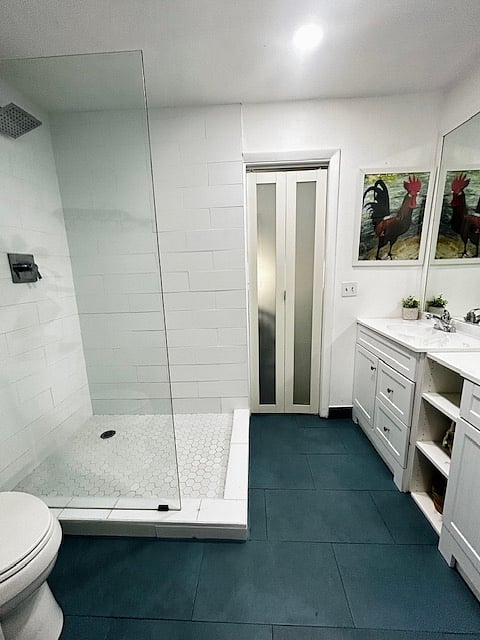 The second bathroom is connected to the second bedroom through the pocket door. This bathroom also has a door that leads to the hallway,