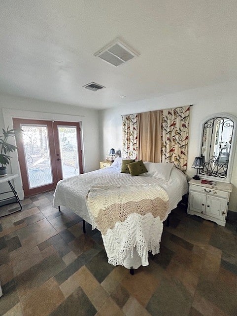 master bedroom 1 with bathroom and door to the back patio.