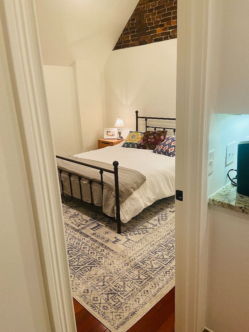 entrance to bedroom with queen bed