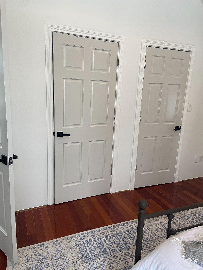 door on the right is the bedroom walk-in closet. door on the left is the washer/dryer
