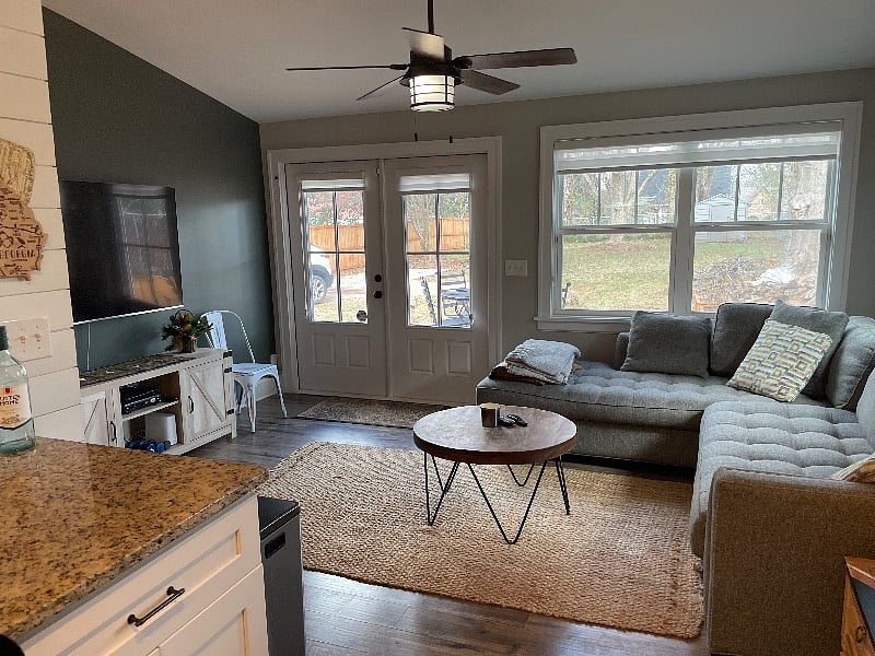 Living room with French doors to outside deck and large backyard