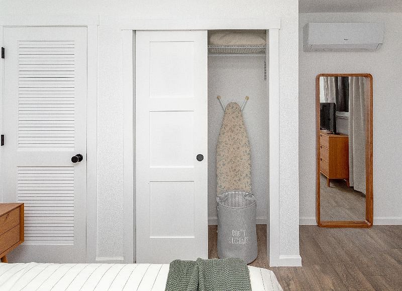 Full size ironing board and laundry basket in the bedroom closet. Full length mirror.