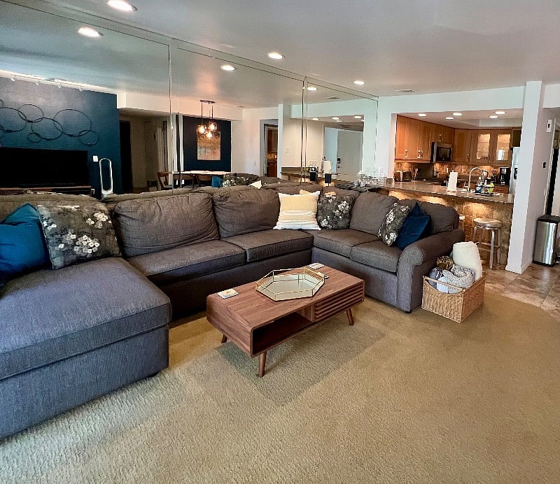 A large living room adjoins the breakfast bar/open kitchen and dining area. The sectional couch has a double pull-out bed for extra guests.
