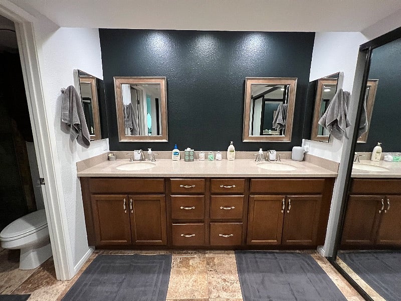 The corner primary suite's ensuite bath has double sinks and a walk-in shower and toilet in a separate room.