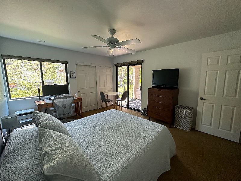 The second bedroom walks out to the covered patio and includes a 32 inch HD TV, connected workspace, and separate seating area with plenty of storage in a large dresser, two nightstands, and in-room closet.