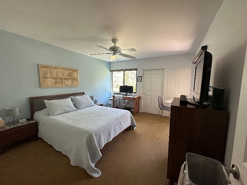 The second bedroom walks out to the covered patio and includes a 32 inch HD TV, connected workspace, and separate seating area with plenty of storage in a large dresser, two nightstands, and in-room closet.