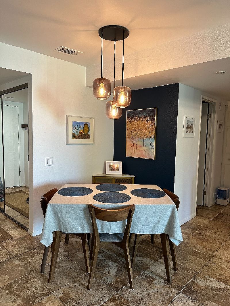 The dining area is adjacent to the living room and kitchen / breakfast bar area for extra seating.