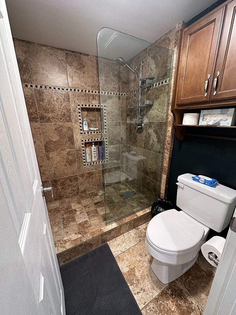 The corner primary suite's ensuite bath has double sinks and a walk-in shower and toilet in a separate room.
