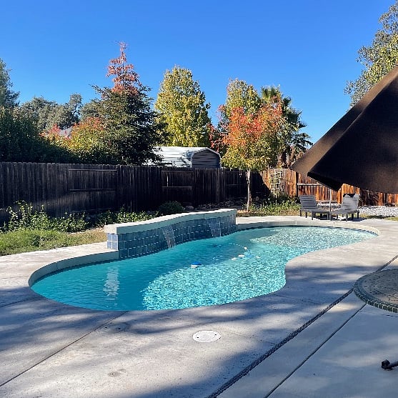 Gunite pool with waterfall and shallow end for chair lounging
