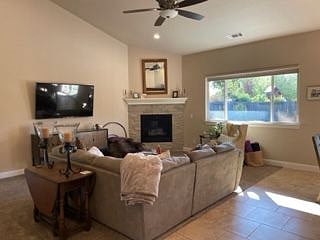 Living room with corner fireplace and view of rear yard