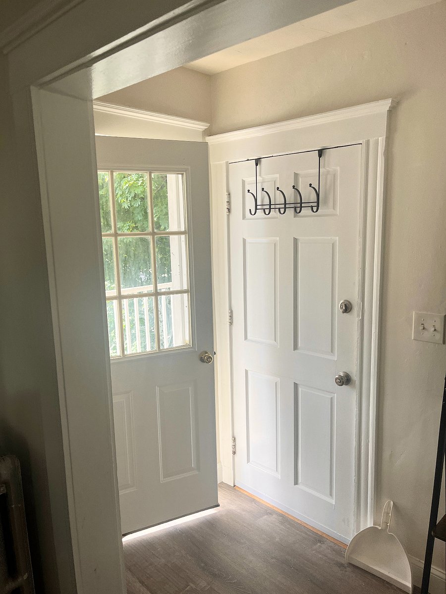 Patio door onto bright leafy street.