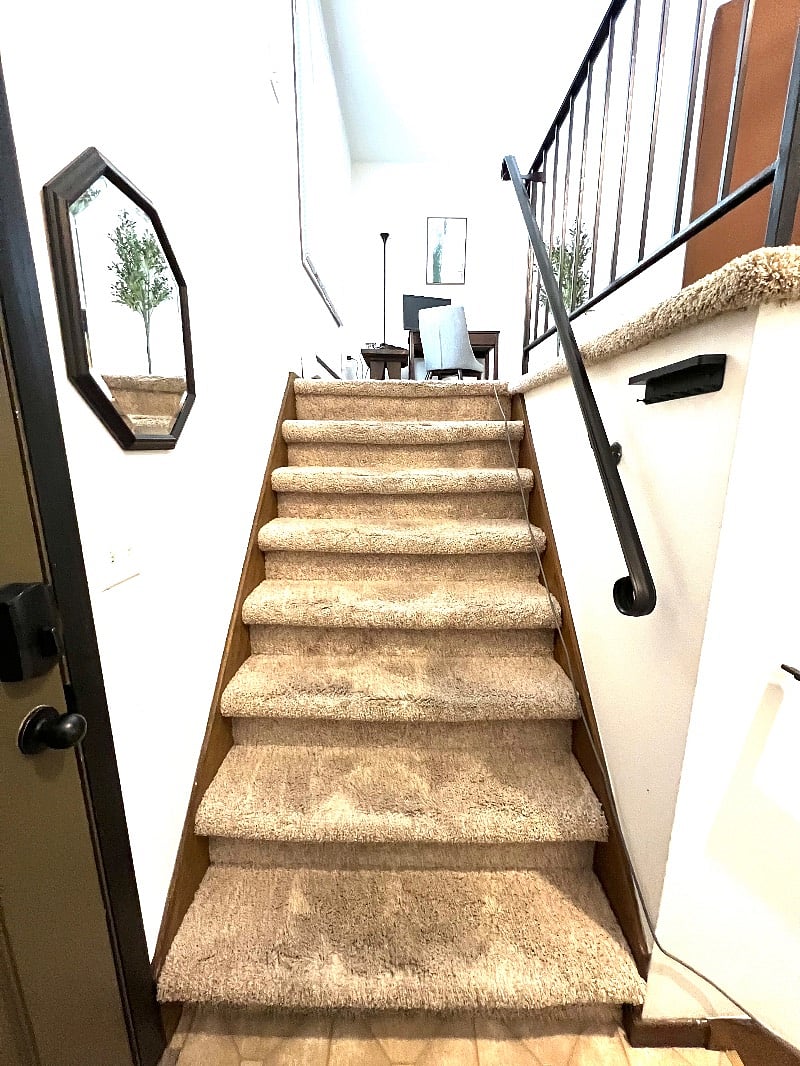 Stairs to upper level with desk and supplies