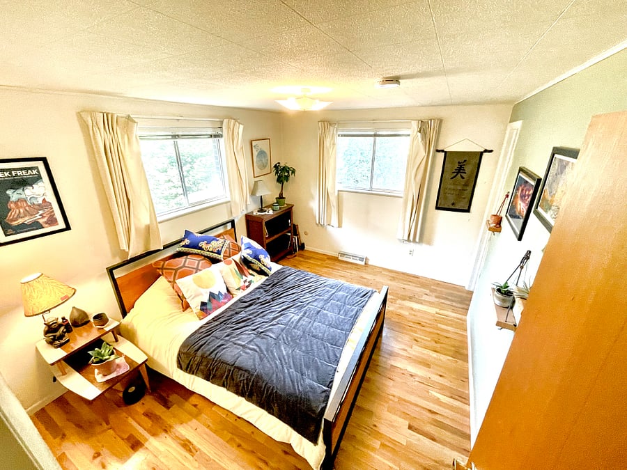 Master bedroom with a queen bed, great south and west facing windows to bring in natural light.