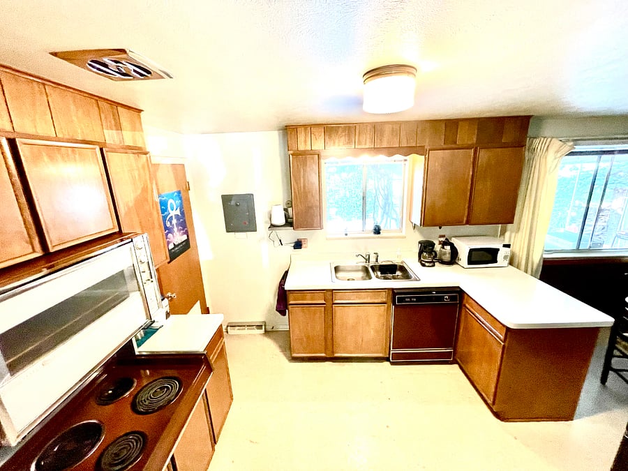 Washing machine, stove, oven, microwave in this mid-century modern kitchen makes it a chef's delight.