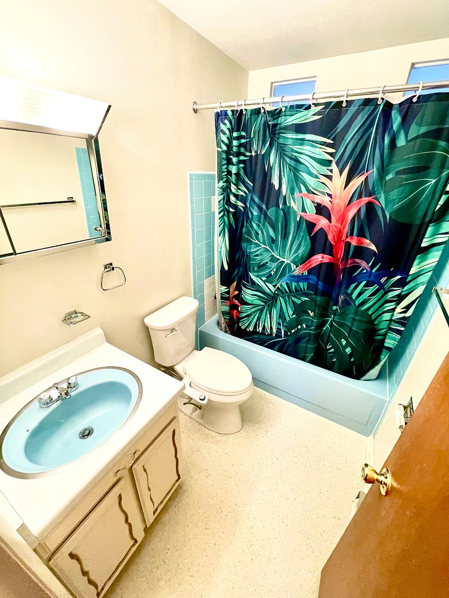 Full size bathroom with bathtub and a vanity for storage.