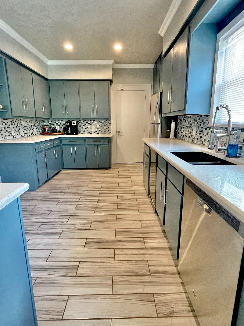 Full kitchen with stainless steel appliances, full range, microwave, refrigerator and wine cooler. Door shown leads to laundry room.