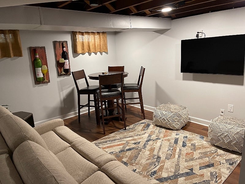 Partially furnished basement that can be used as an entertainment room.