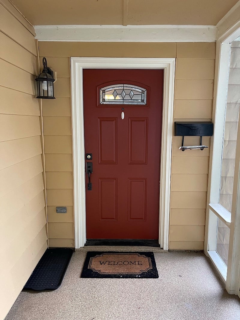 Front door. There is a front, screened porch with furniture as well.