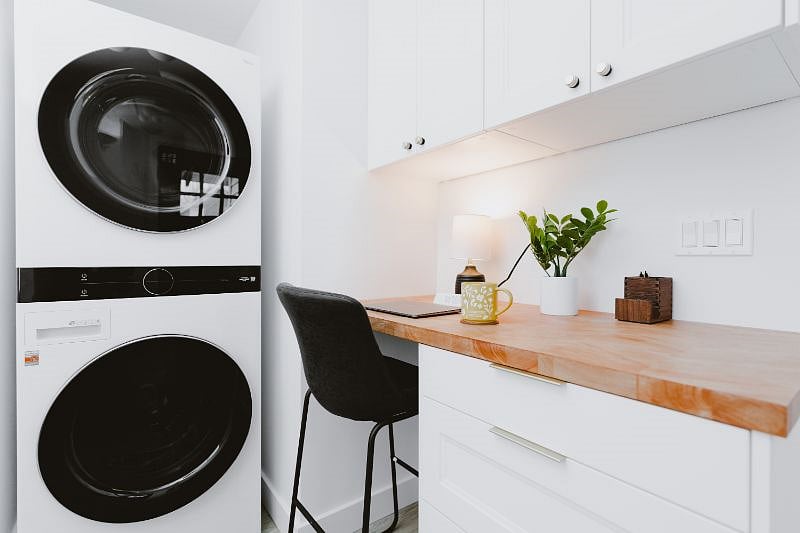 The mudroom/office area has a builtin desk area with storage (also doubles as a laundry folding station), full size washer and dryer, and storage for coats/shoes and a pantry area.