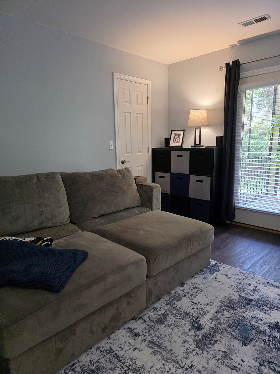 Office (second bedroom) has a large LoveSac couch that doubles as a queen sized bed, cube storage, L-shaped desk, and large TV.