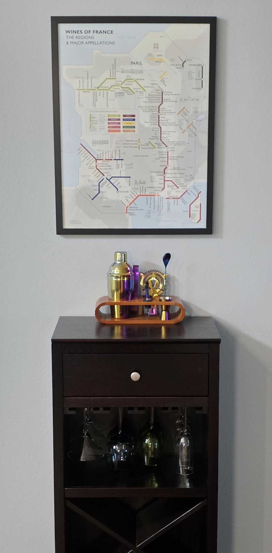 Fun bar cart with a full set of cocktail tools, wine storage, and various glasses.