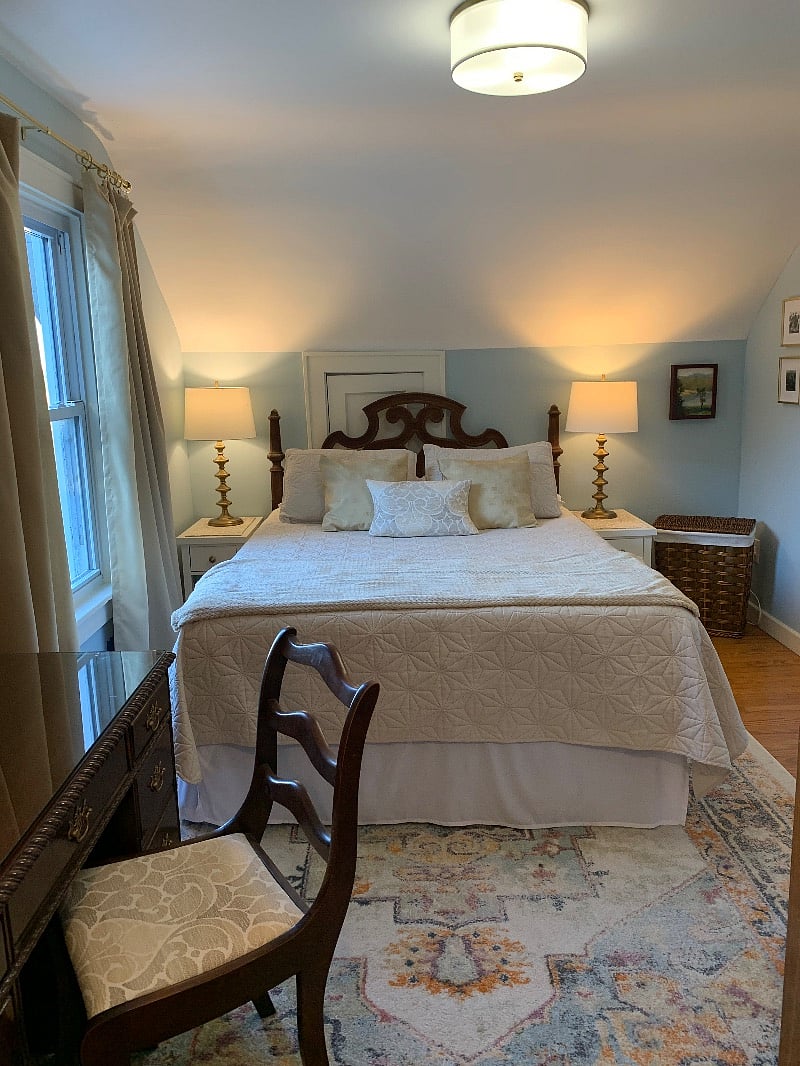 Queen bed with another river view out the window. 