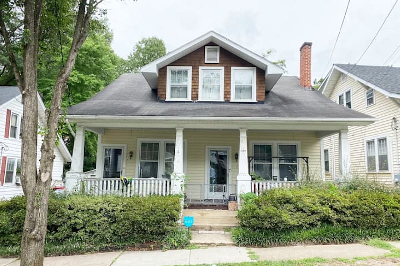 The entry to the second floor is the exterior door to the left of the porch.