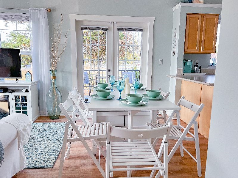 Dining table folds up and is stored out of the way, providing more living space.