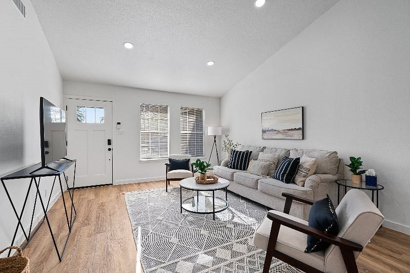 A spacious living room with plenty of seating for relaxing and gathering.