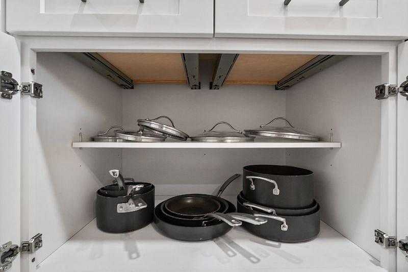The kitchen is stocked with a variety of pots and pans with lidsperfect for everyday cooking.