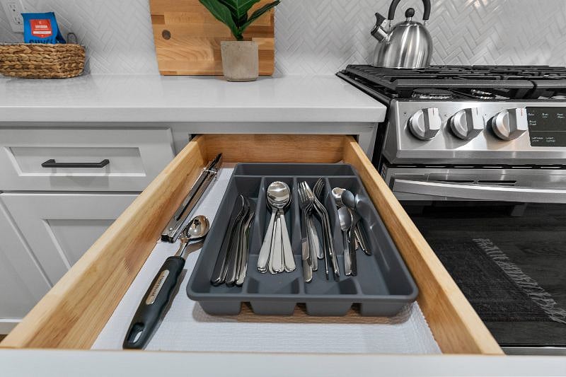 The kitchen is stocked with all essential silverware and utensils for everyday use.
