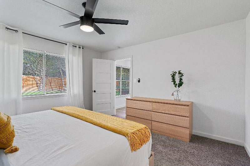 The primary suite includes a six-drawer dresser and light-blocking curtains to enhance comfort and promote restful sleep.