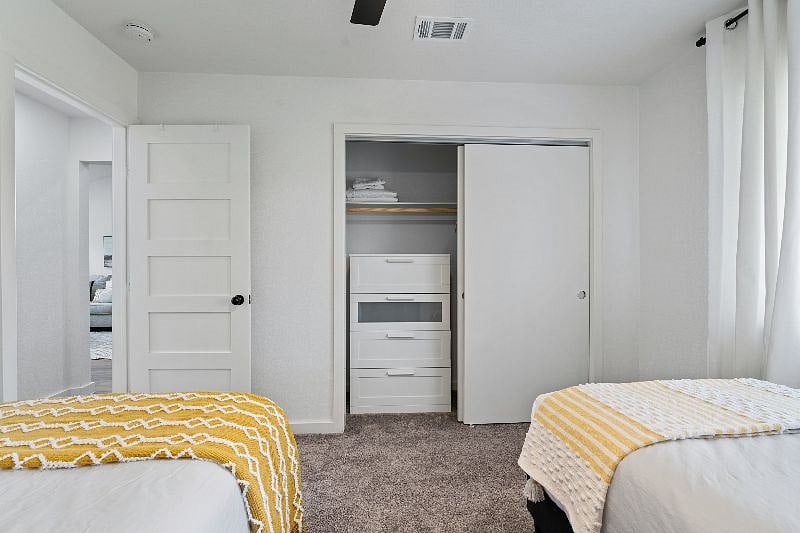 The secondary bedroom offers a closet and a four-drawer dresser, providing convenient storage for your stay.