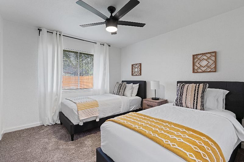 The secondary bedroom is thoughtfully appointed with two Twin XL, luxury-rated mattresses and light-blocking curtains to enhance comfort and restful sleep.