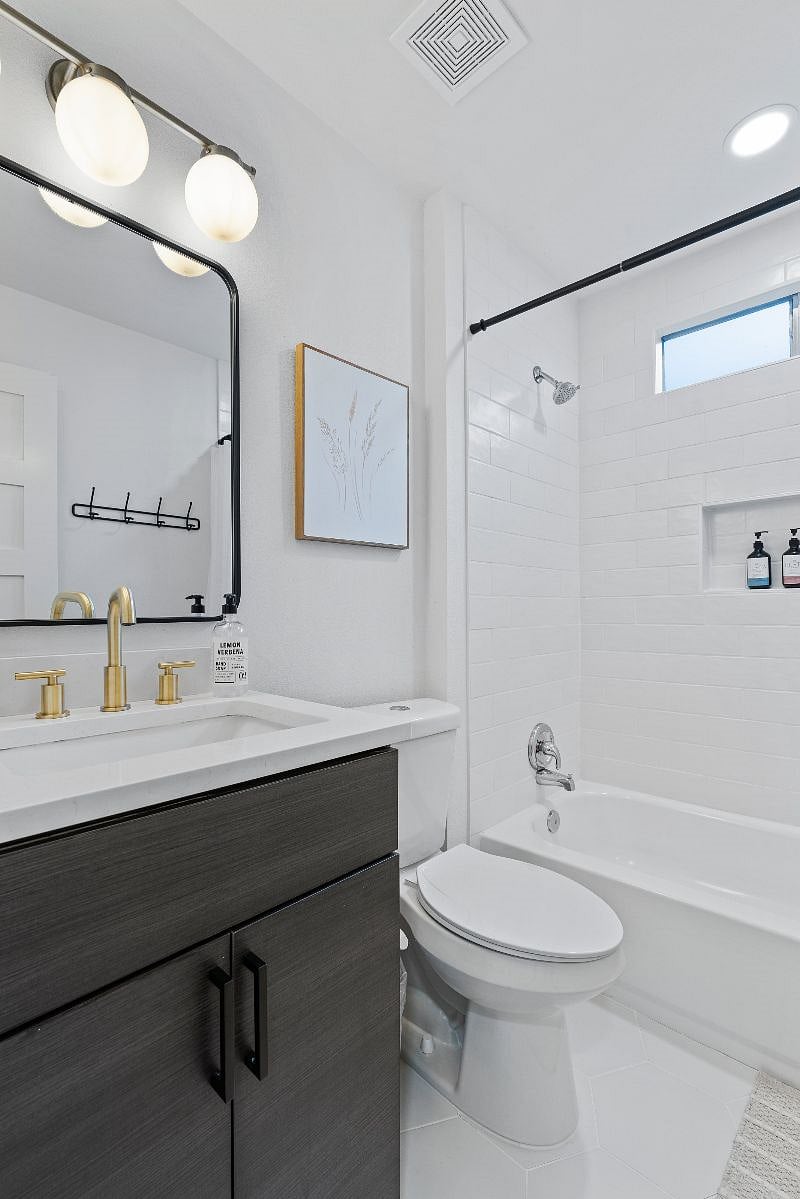 The hall bathroom includes a tub/shower combo and a starter supply of shampoo, conditioner, and body wash for your convenience.