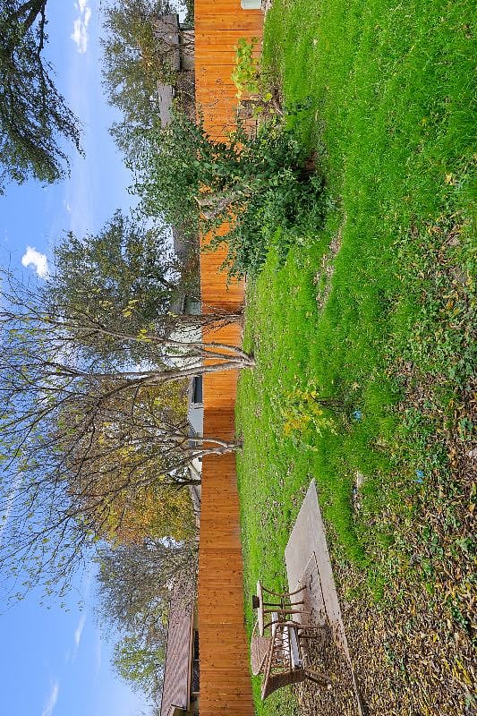 Big fenced in backyard with a locked gate.