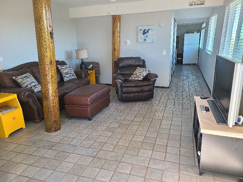 Living room with leather couch, recliner and rv