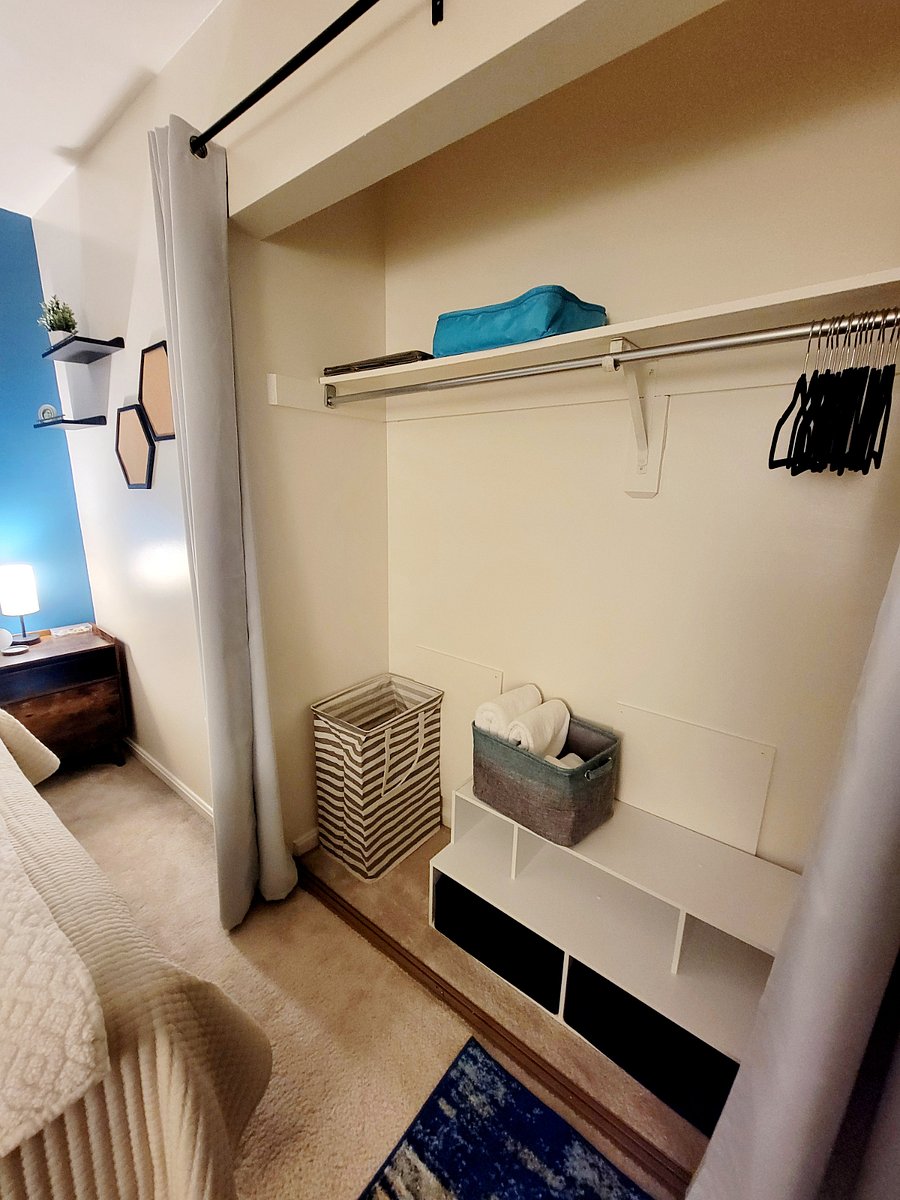 Closet with hangers, hamper, extra linens, hanging storage, overhead shelving, floor cubbies and cube storage.