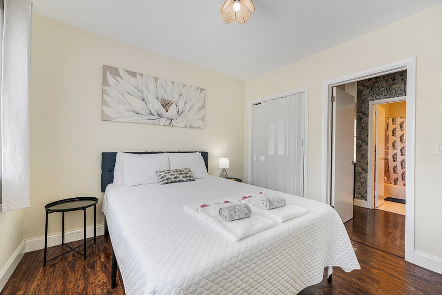 A serene and fully furnished bedroom featuring a queen bed, dresser, and closet, your perfect space to rest and recharge.