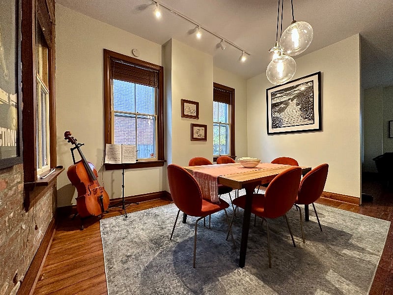 Theres a record player in this room, behind where the photographer stood when taking this photo. Play a record while you enjoy your dinner!